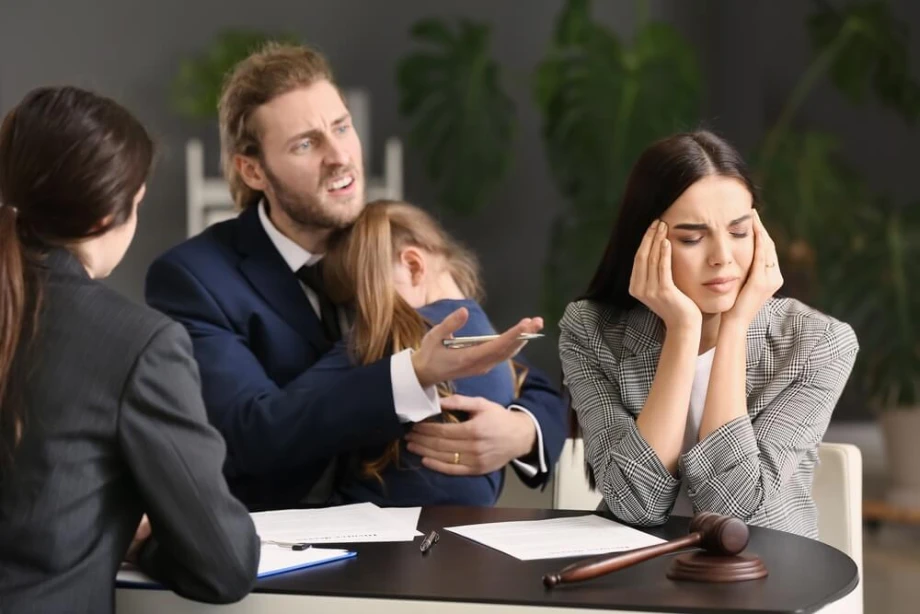 Mother and father with a lawyer discussing child support agreement