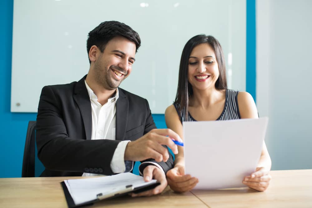 Young couple signing prenup documents