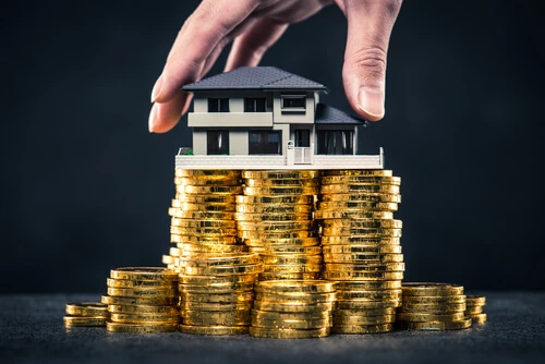 A large amount of money and house model