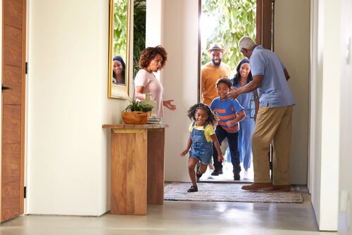 Opening Door To Visiting mother With Children Running